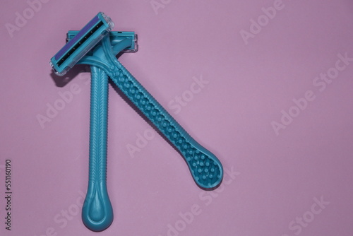blue Gilette razors on a pink background