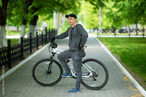 Man in sportswear cycling in the park