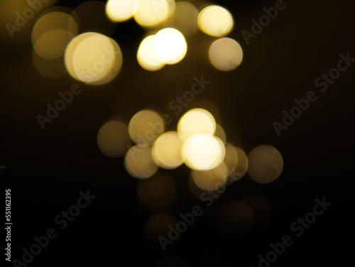 Golden and dark brown round bokeh lights festive background