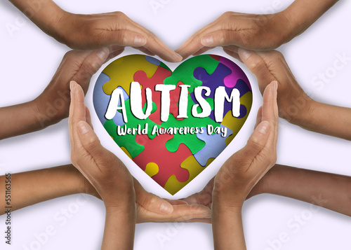 Fototapeta Naklejka Na Ścianę i Meble -  World Autism Awareness Day. People forming heart with their hands on white background, top view