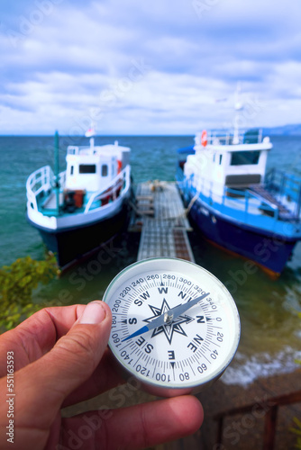 The right compass is always needed for travelers, adequate course. Hiking on the shore of Lake Baikal in Siberia. Pleasure craft photo