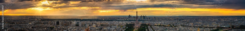 Aerial sunset panorama of Paris with Eiffel Tower in the center. France