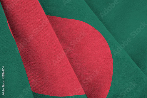 Bangladesh flag with big folds waving close up under the studio light indoors. The official symbols and colors in fabric banner photo