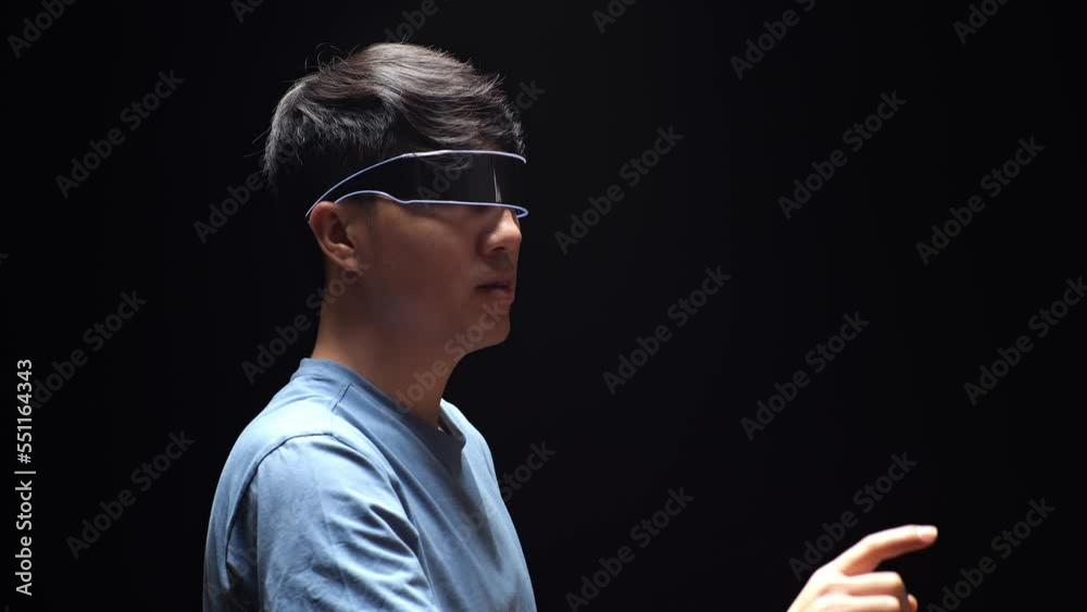 Close Up Side View Of Asian Man Experience Virtual Reality In Futuristic Goggles. Player Touching Air Panel
Close Up Side View Of Asian Man Experience Virtual Reality In Futuristic Goggles. Player Touching Air Panel
