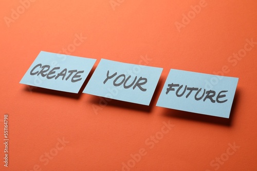 Motivational phrase Create Your Future made of sticky notes with words on orange background