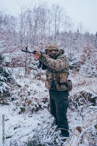 a member of the international legion in the middle of enemy territory. With assault rifle, ballistic vest and camouflage