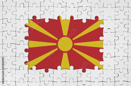 Macedonia flag in frame of white puzzle pieces with missing central parts photo