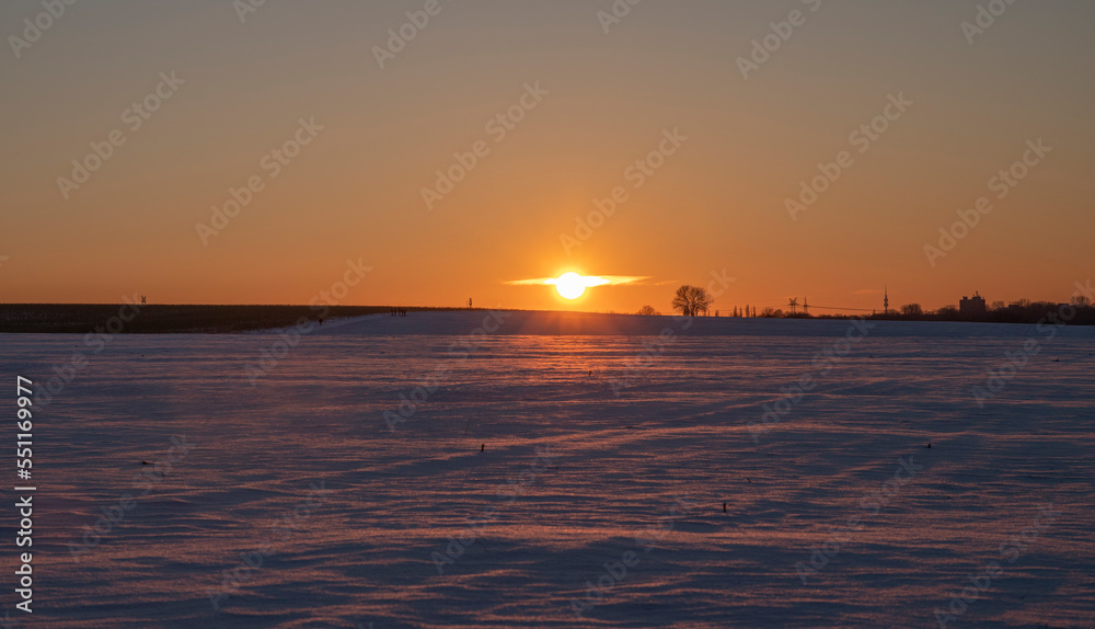winter landscape and sunset against the background of snow