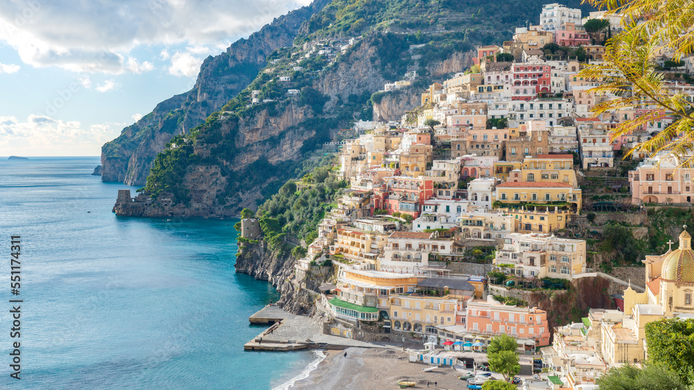 The pearl vertical city of the Amalfi Coast: Positano, the large beach, the church and the two ancient Saracen towers. Italy