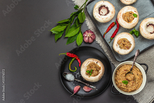 Raw stuffed mushroom caps ready for baking. Fresh champignons, spices, vegetables. Cooking process