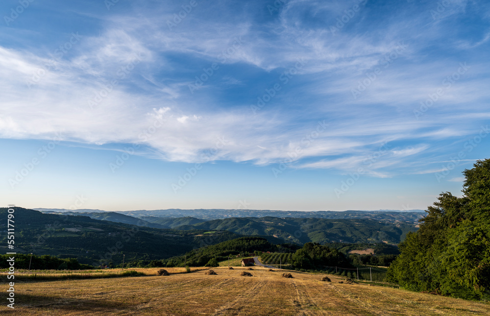 Round bales of hay or straw rolled up on field in the mountain scenery, autumnal harvest scenery Round bales of hay or straw rolled up on field in the mountain scenery, autumnal harvest scenery