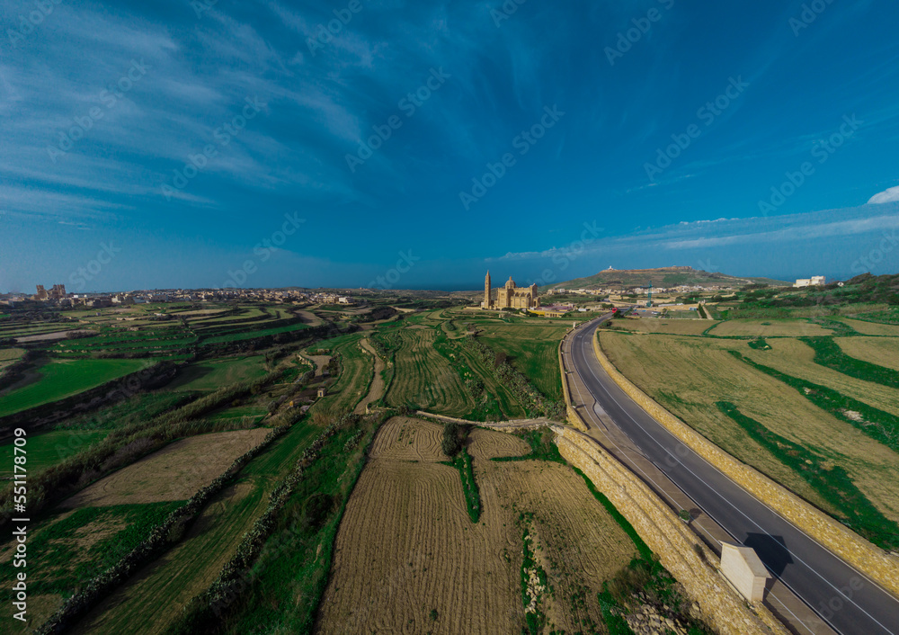 Large Drone panorama or majestic and big Basilica of the National Shrine of the Blessed Virgin of Ta' Pinu on the island of Gozo, Malta on a sunny day.
