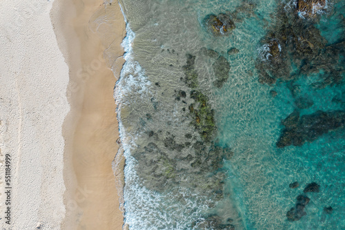 Stunning aerial view of a beach with pristine blue water