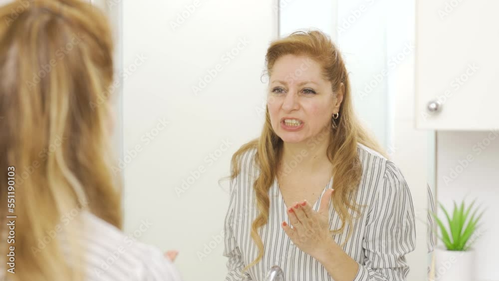 Talking to yourself in front of the mirror.
Mature woman talking to herself looking in mirror and frustrated. Mental illnesses.
Talking to yourself in front of the mirror.
Mature woman talking to herself looking in mirror and frustrated. Mental illnesses.