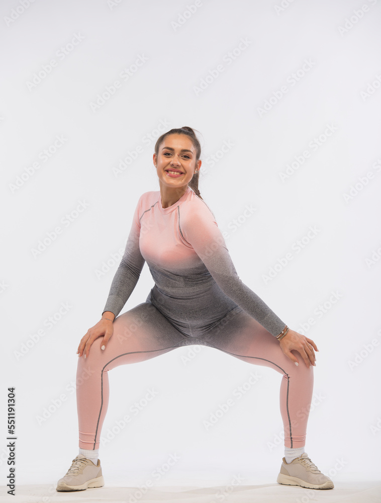 young woman doing fitness exercises on a white background isolated.sports exercises for body shaping
