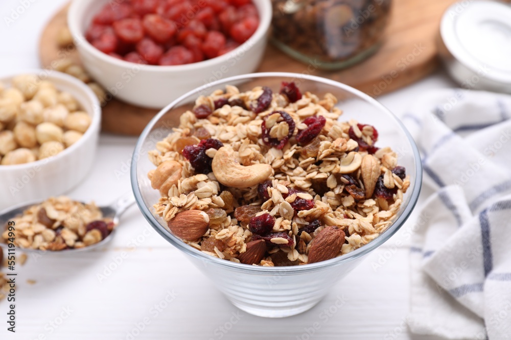 Bowl of tasty granola on white wooden table Bowl of tasty granola on white wooden table