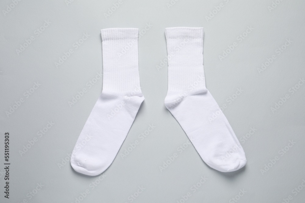 Pair of white socks on light grey background, flat lay Pair of white socks on light grey background, flat lay