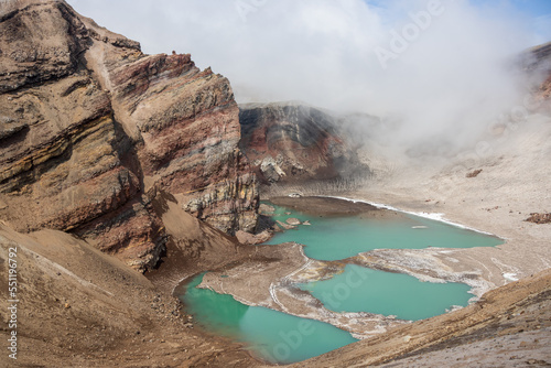 View of the volcano crater. Majestic mountain landscape. Lake in a volcanic crater. Travel, tourism and hiking on the Kamchatka Peninsula. Nature of the Far East of Russia. Gorely volcano, Kamchatka. photo