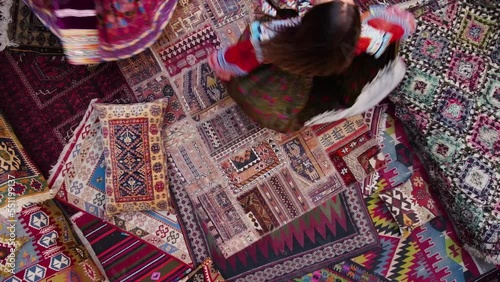 Two girls in dress spinning on national carpets of Turkey in Cappadocia