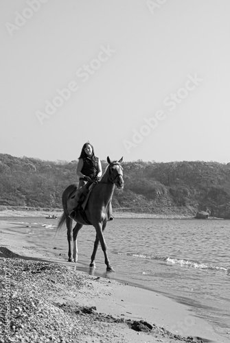  Girl and horse. Horse riding by the sea.