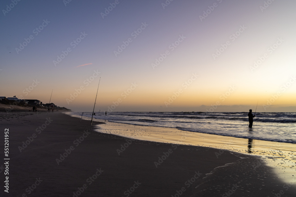 Lonely Sunrise Surfcaster on Beach