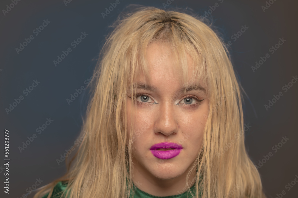 Young blond LA citizen poses in studio wearing a green leotard and jeans. Young blond LA citizen poses in studio wearing a green leotard and jeans.