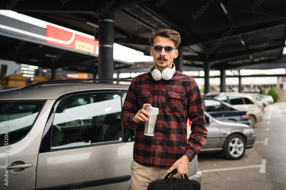 one man happy caucasian male standing at the parking lot in day one man happy caucasian male standing at the parking lot in day