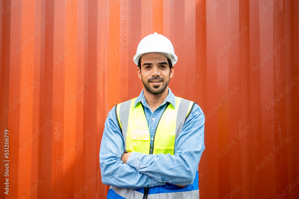 Portrait of confident young hispanic male engineer with container background. Portrait of confident young hispanic male engineer with container background.