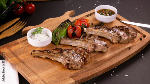 Pirzola Meat Kebabs Tomatoes and Onions and Grits on a board