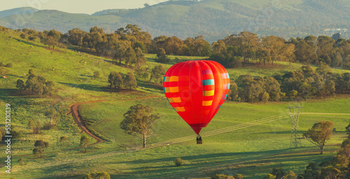 Hot air balloon avoiding power lines and trees during landing on the outskirts of Canberra, Australia. 