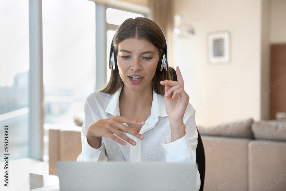 Busy freelancer girl in wireless headphones talking on video call at laptop. Coach woman, business blogger giving webinar, shooting online workshop, using gadget for Internet communication Busy freelancer girl in wireless headphones talking on video call at laptop. Coach woman, business blogger giving webinar, shooting online workshop, using gadget for Internet communication
