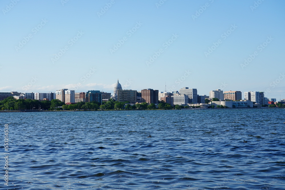 City landscape photo of Madison, Wisconsin capitol and city buildings from Olin park