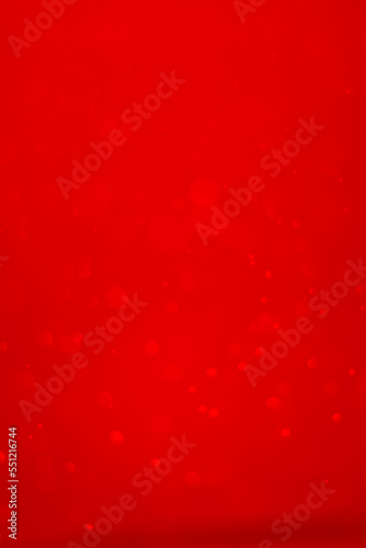 Red glitter vintage lights background.  Red bokeh shiny on dark background. Vertical photos