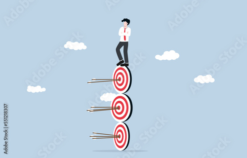 Professional working to finish business projects, precision marketing, multitasking skill concept, Confident businessman standing on stack of archery targets with bullseye hitting.