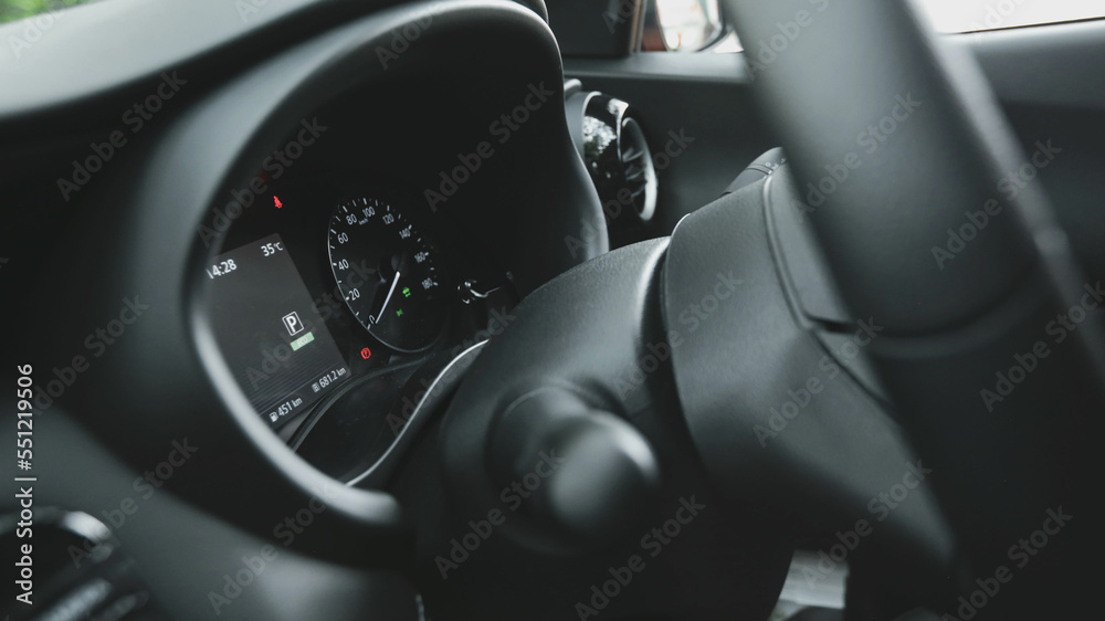 close-up of car start and stop buttons. Modern car interior with cockpit dashboard and steering wheel details