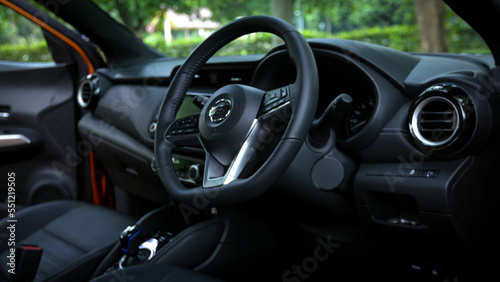 close-up of car start and stop buttons. Modern car interior with cockpit dashboard and steering wheel details © Deki Prayoga