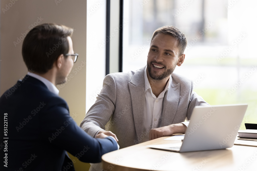 Two businessmen finish successful negotiations with shake hands, make profitable deal feel satisfied, accomplish business formal meeting. Sales manager and client greeting each other start appointment Two businessmen finish successful negotiations with shake hands, make profitable deal feel satisfied, accomplish business formal meeting. Sales manager and client greeting each other start appointment