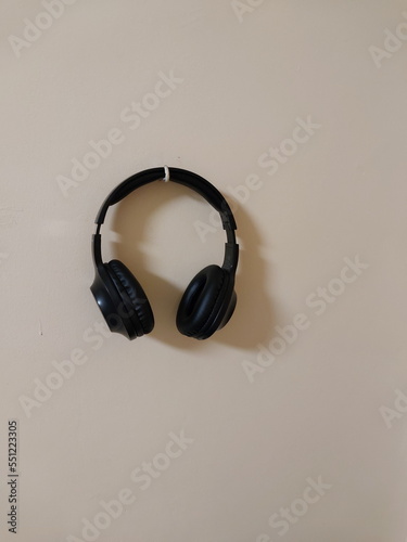 Hanging wireless black headphones on the wall