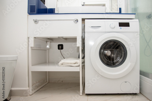 Wallpaper Mural bathroom interior, minimalist apartment design with toilet and washing machine in white and blue color Torontodigital.ca