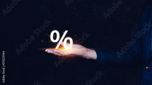 Businessman holding with percentage sign, monetary growth, interest rate increase, inflation concept, Interest rate financial and mortgage rates concept.