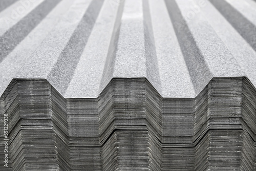 Metal profile for roof covering. Metal profiled sheeting is stored in a bundle in a warehouse for sale. photo