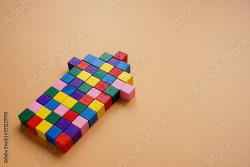 An arrow of multi-colored cubes as a symbol of unity, cooperation and teamwork.