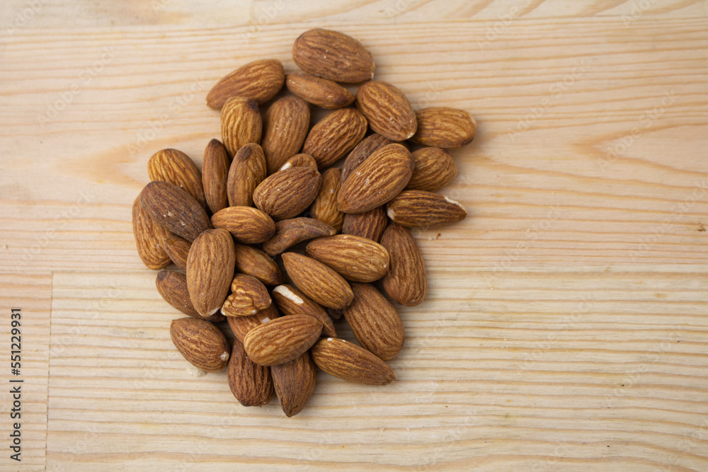 Roasted almonds on wooden background Roasted almonds on wooden background