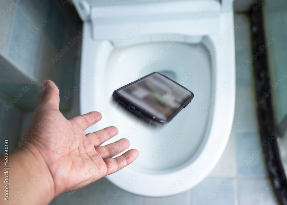 Fototapeta premium Phone fell in the toilet bowl cannot keep up,Safety concept