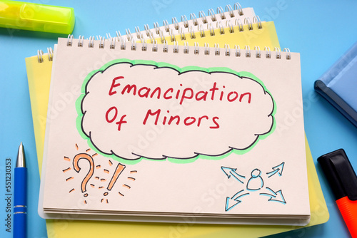 Fotografie Page in a notepad with written inscription emancipation of minors