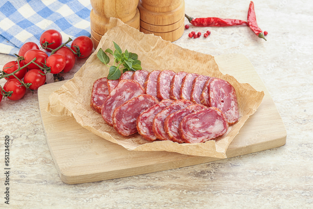 Sliced salami sausages over board Sliced salami sausages over board