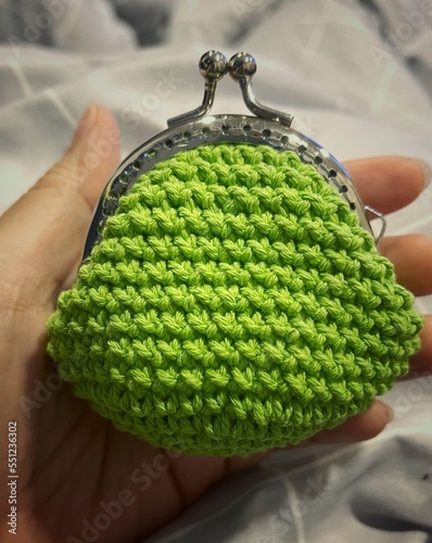 green purse with coin Close up a small clutch bag crochet in vintage style 