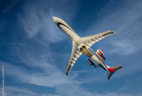 Commercial airliner against a blue sly with clouds
