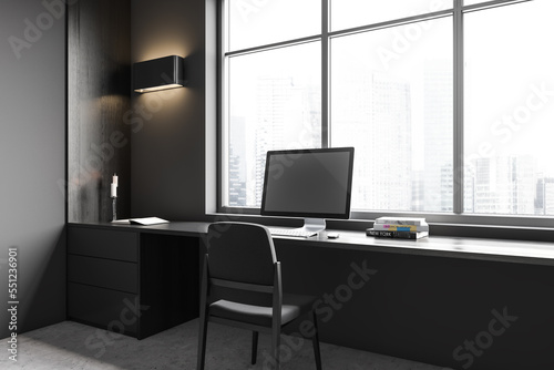Grey business interior with workplace and pc computer, panoramic window