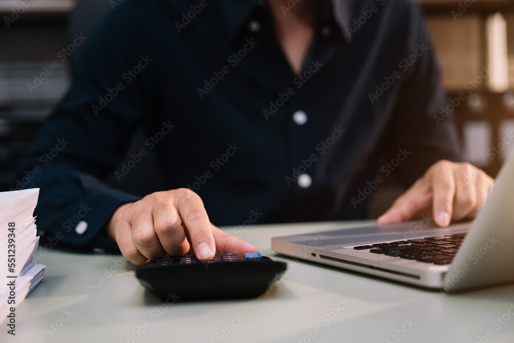 Business and financial concepts about office work. Analysts discuss business with a calculator as a tool. Business and financial concepts about office work. Analysts discuss business with a calculator as a tool.